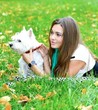portrait of beautiful girl lying with her dog